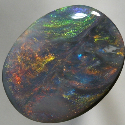 SOLID BLACK OPAL Large opal with moving orange, green and blue SEE VIDEO